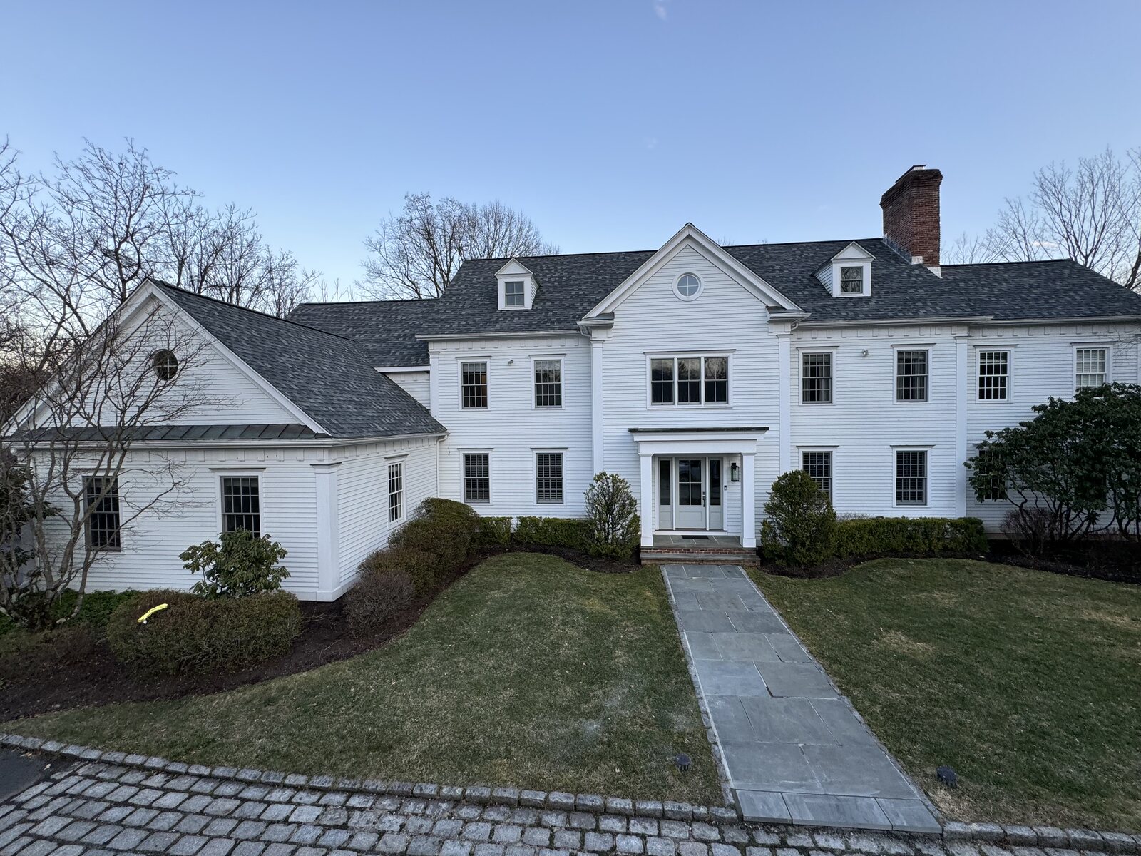 Home exterior with gutters serviced by Level One Roofing